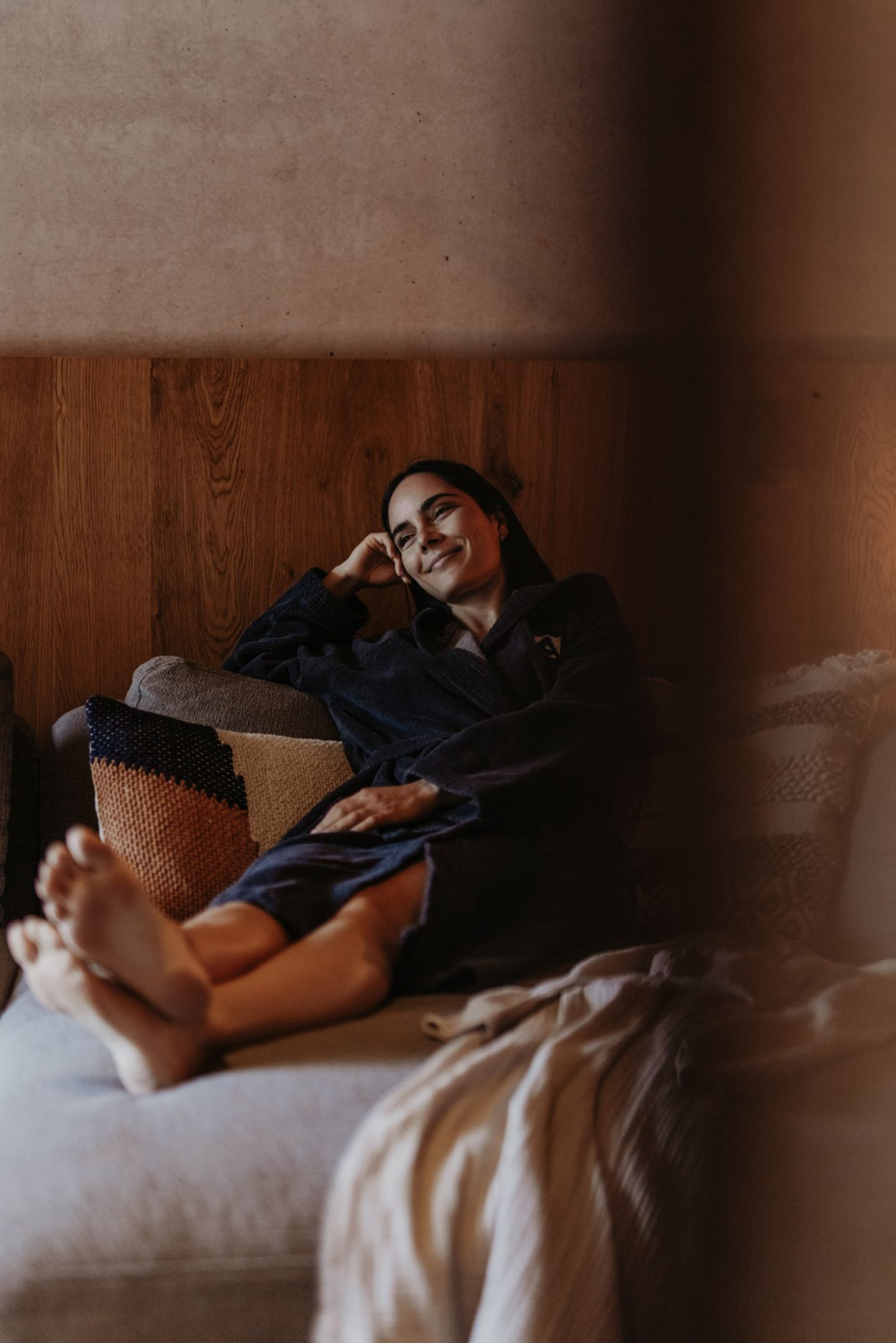 Woman in a bathrobe relaxing on the sofa in the relaxation area